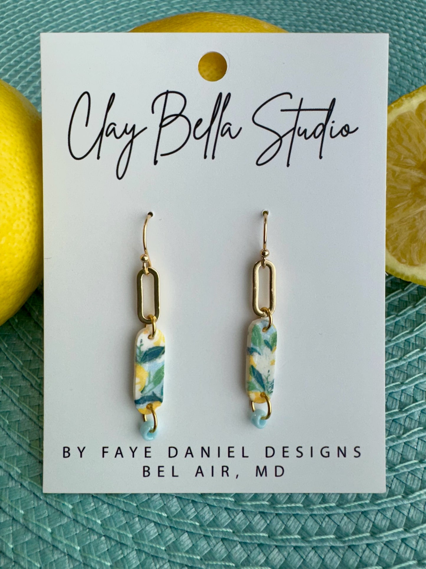 Handmade citrus patterned polymer clay earrings with gold oval link detail