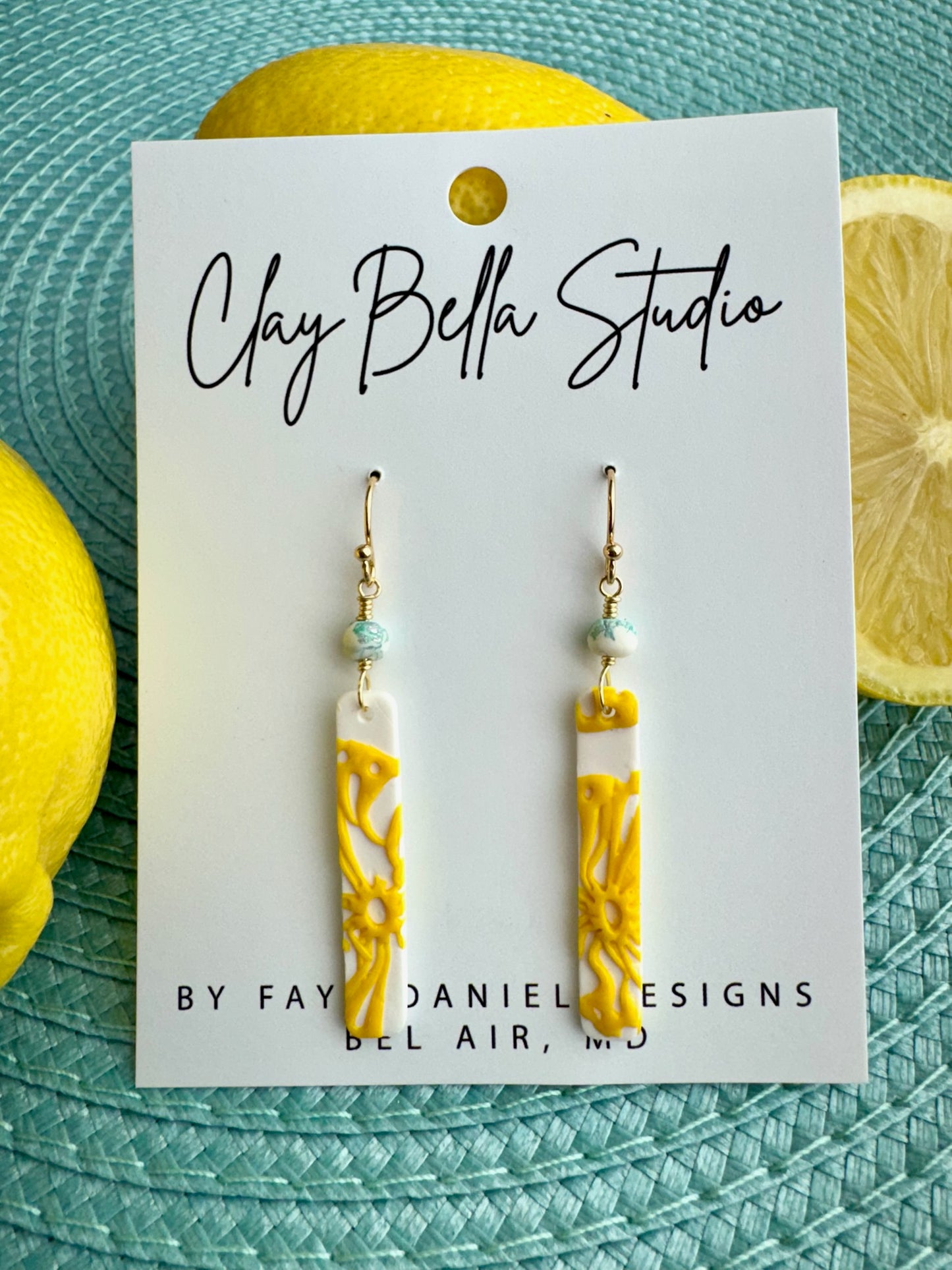 Handmade yellow textured polymer clay drop earrings with citrus-inspired design