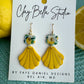 Statement earrings pair lemon colored shells with a soft floral accents 