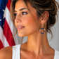 Model wearing Red, white & beautiful handmade patriotic hoop earrings by Clay Bella Studio