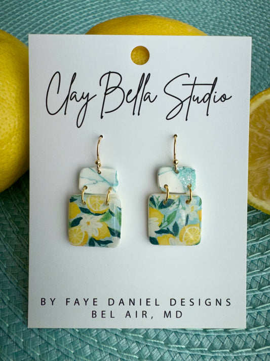 Handmade seaside citrus polymer clay earrings with lemon floral pattern and marbled sea glass top by Claybella Studio