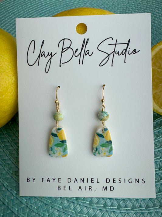 Handmade seaside lemon drop polymer clay earrings with citrus pattern and aqua bead by Claybella Studio