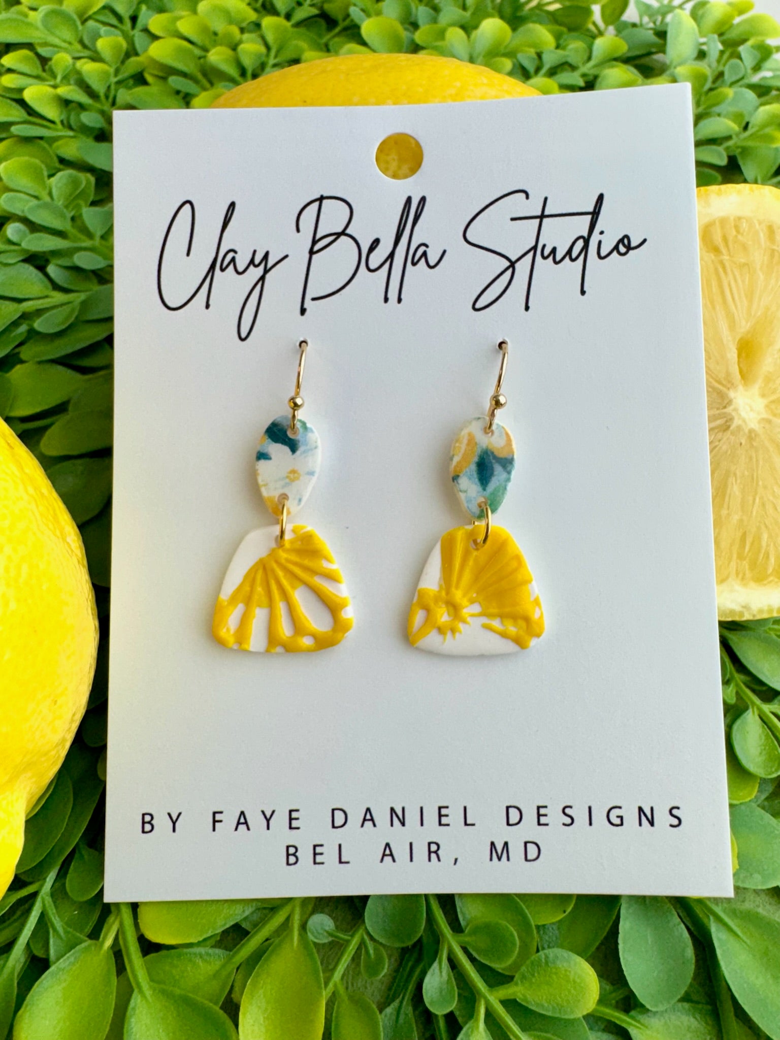 Handmade lemon slice polymer clay drop earrings with yellow citrus design and marbled top by Claybella Studio